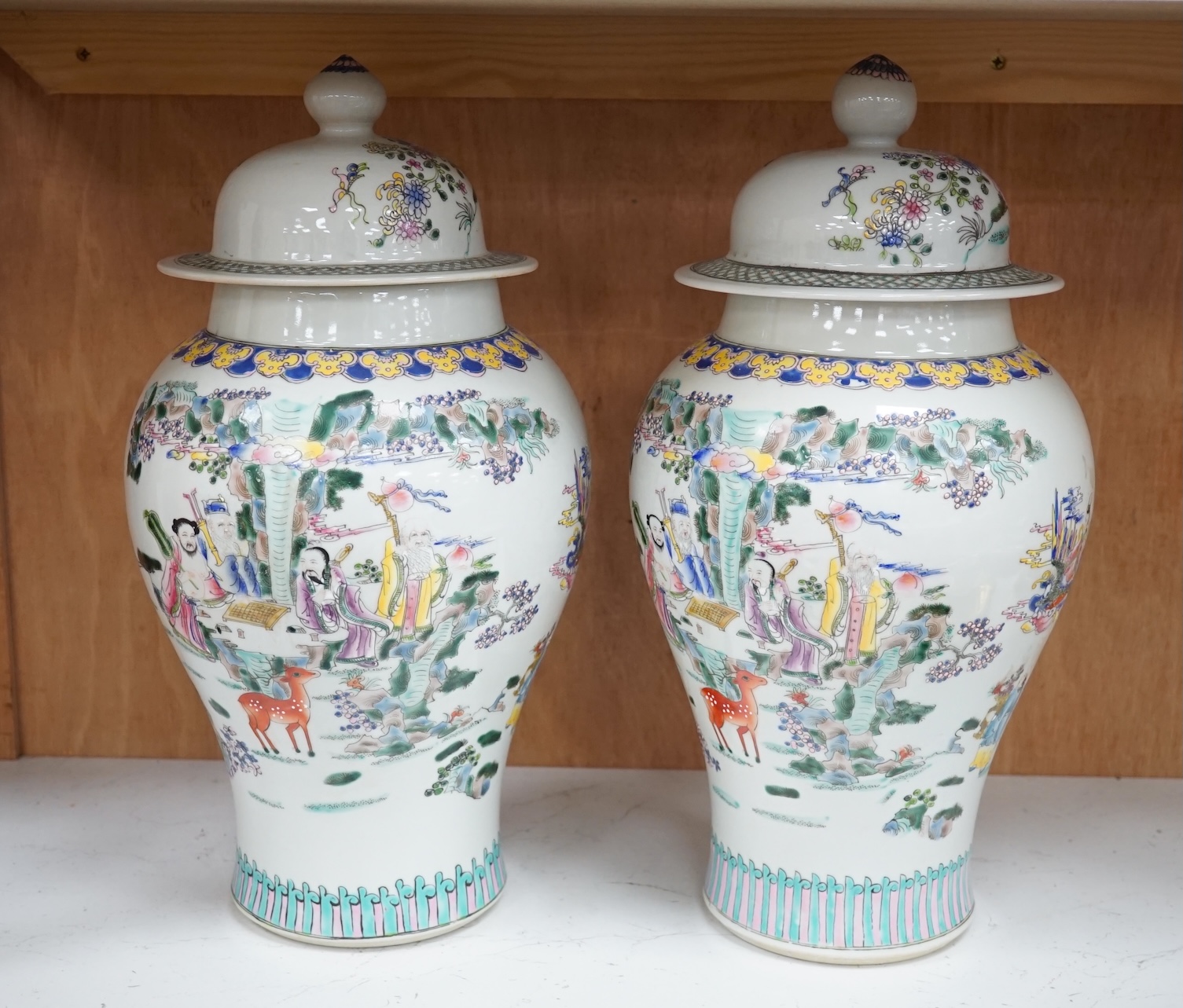 A pair of Chinese famille rose baluster vases and covers, 44cm high. Condition - good